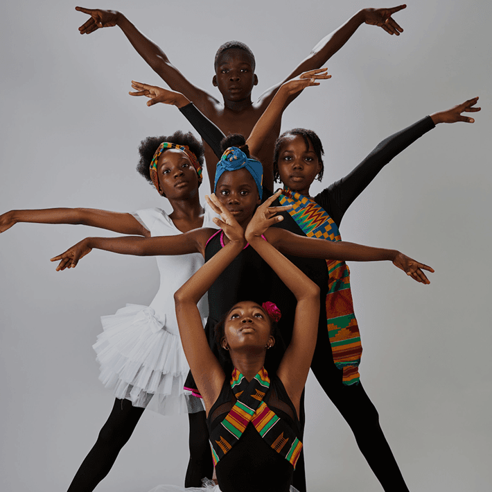 Dancers in colorful traditional attire in an artistic pose